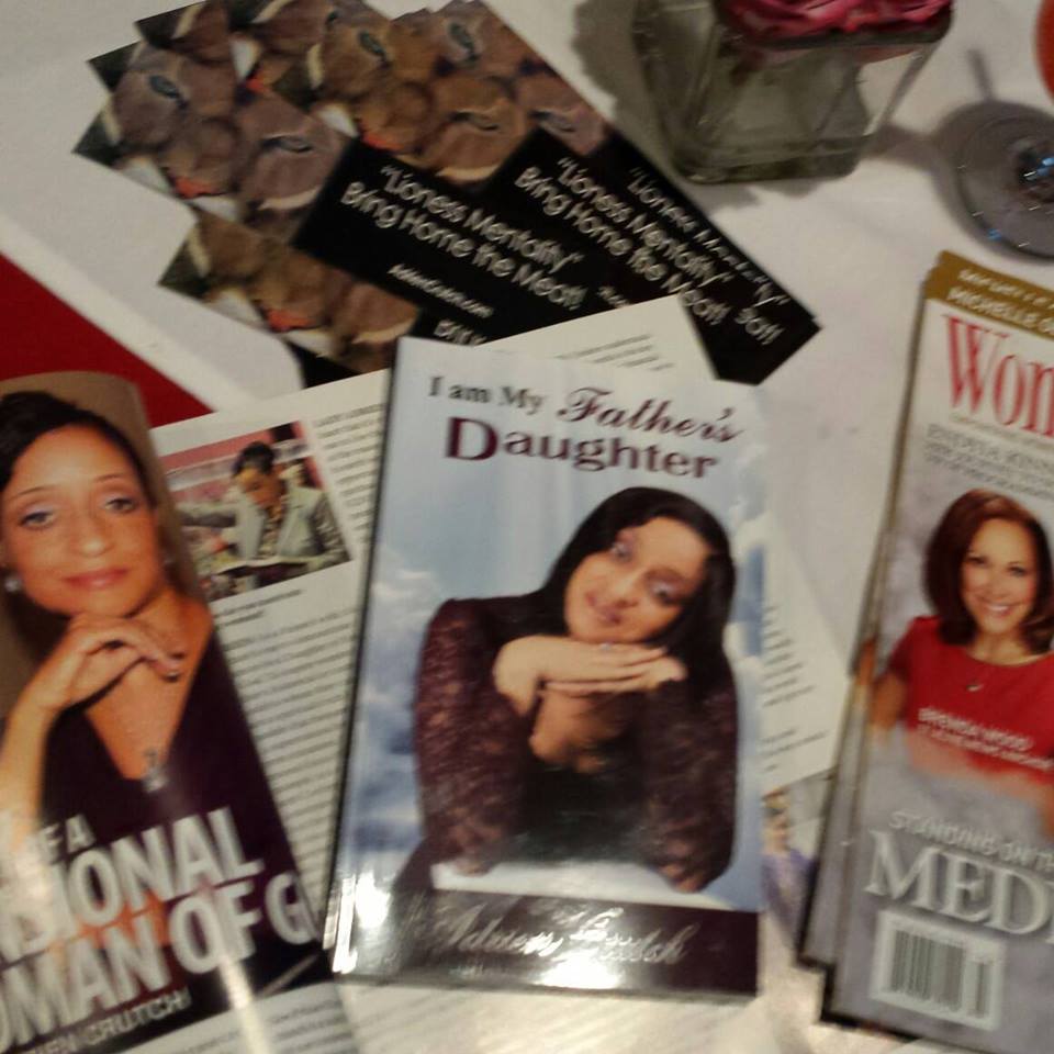 Women gathered around I Am My Father’s Daughter materials